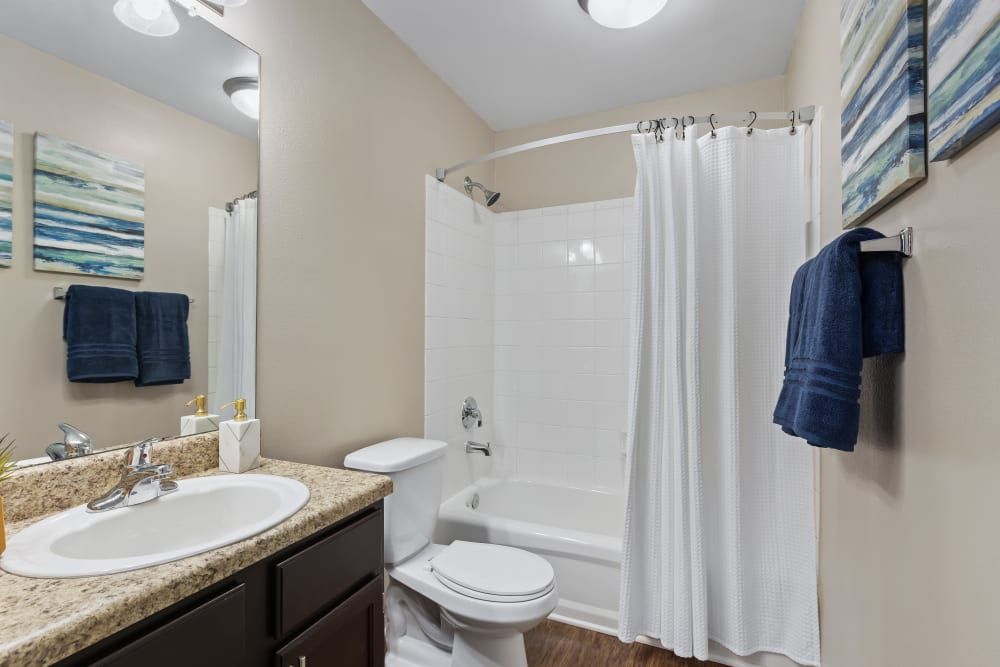 a bathroom with a toilet, sink, and bathtub at Marquis on Cary Parkway in Morrisville, NC.