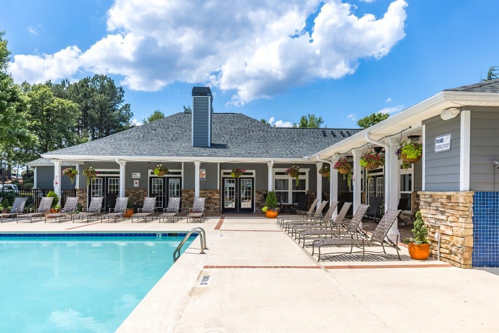a large swimming pool in front of a house at Marquis on Cary Parkway in Morrisville, NC