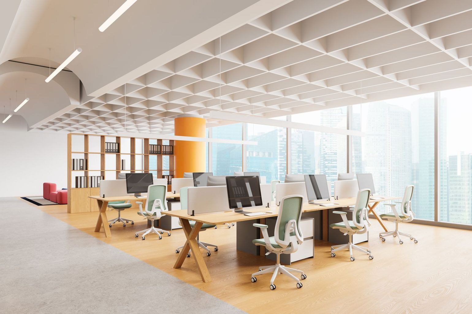 Modern open-plan office with desks, computers, chairs, and large windows in bright daylight
