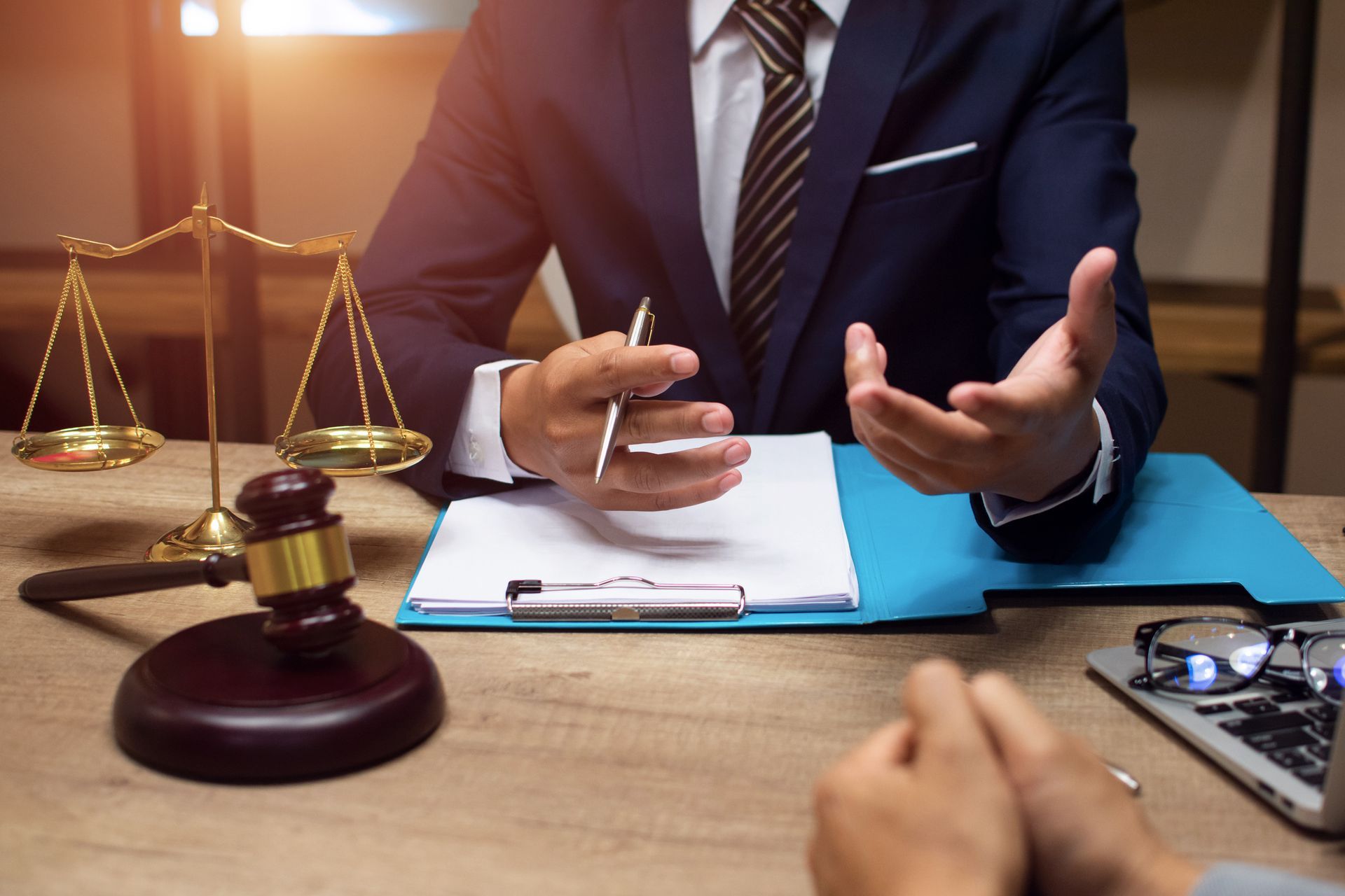 A close-up of a lawyer consulting with a client in his office.
