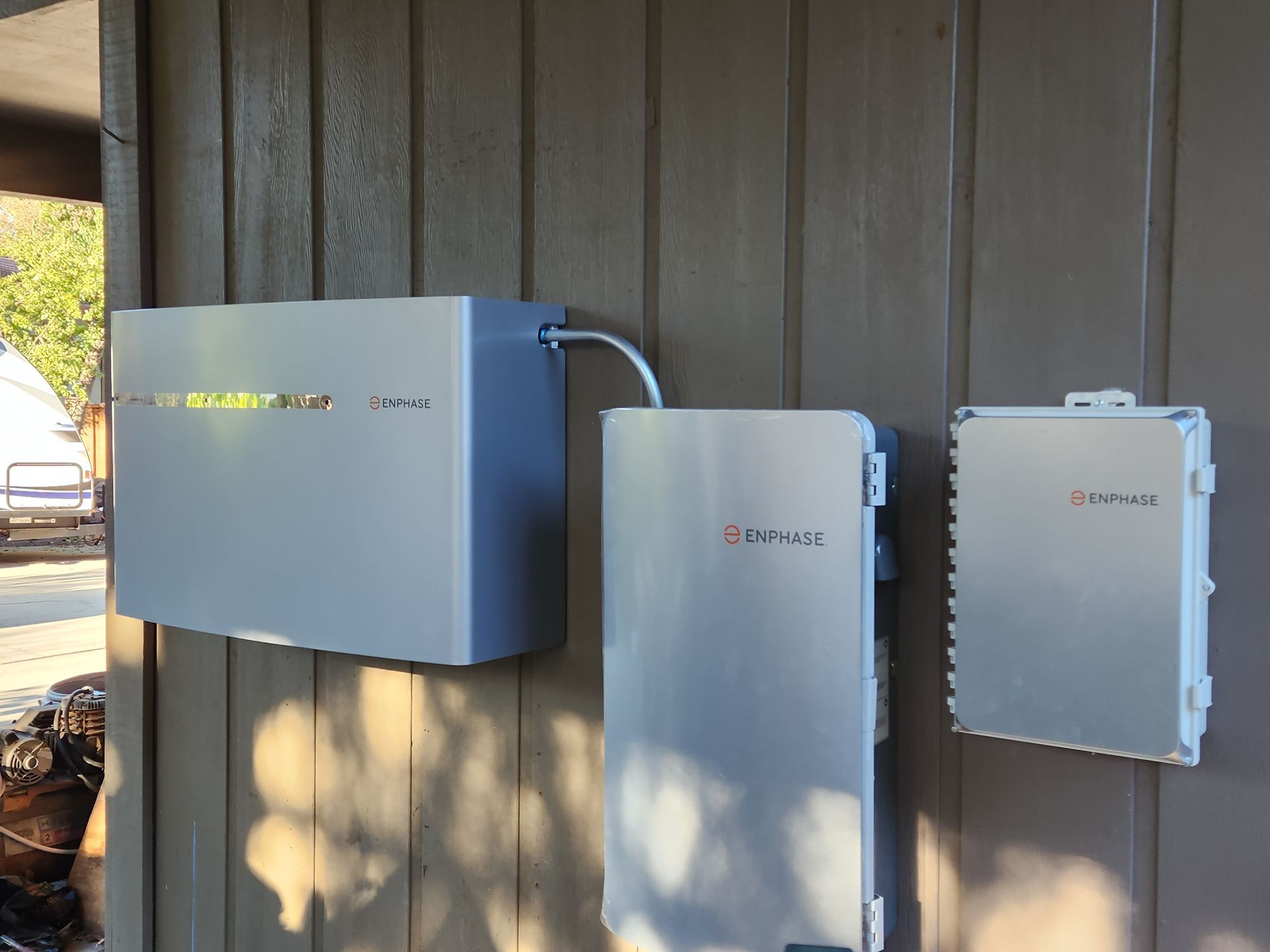 Three white boxes are sitting on a wooden wall.