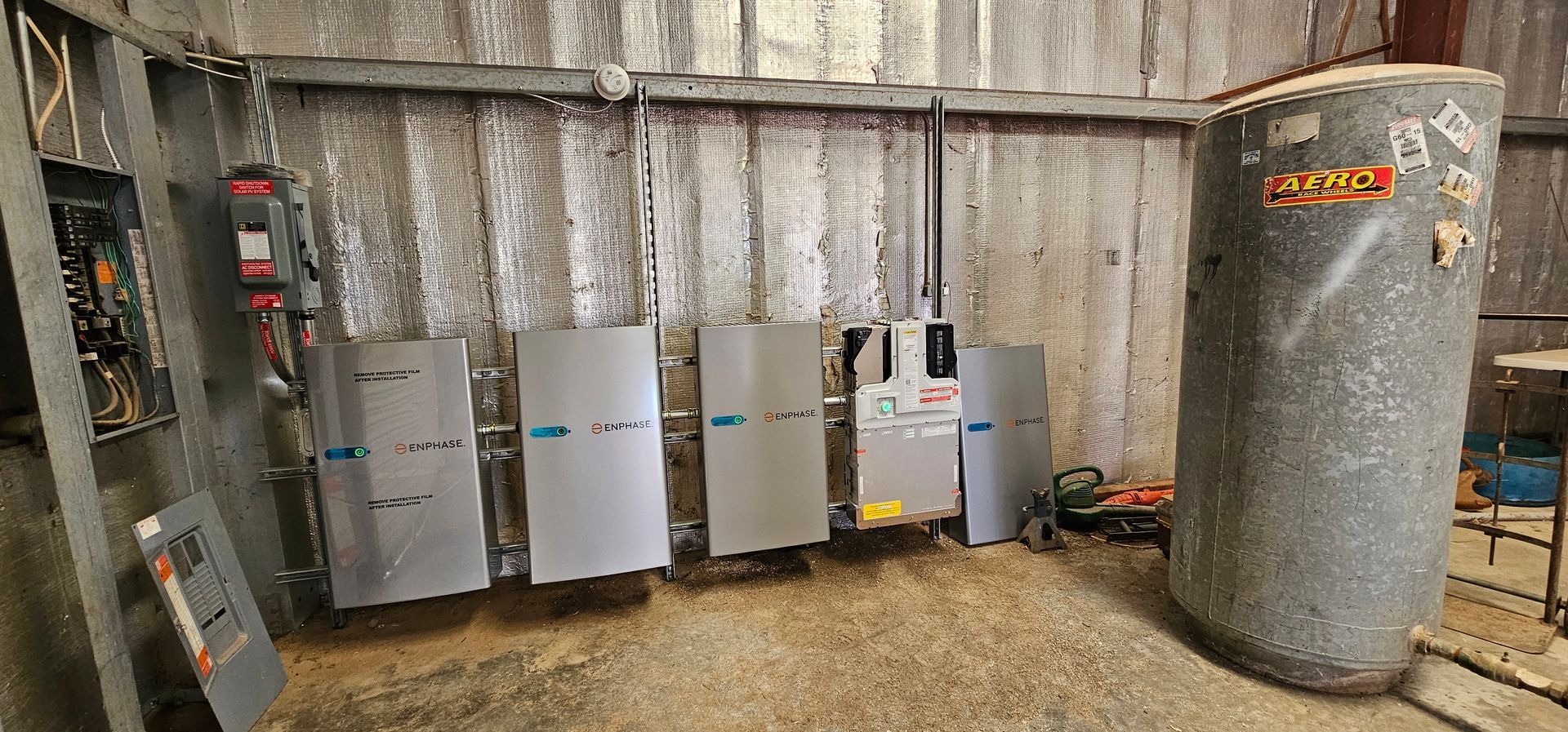 A room with a lot of electrical equipment and a large tank.