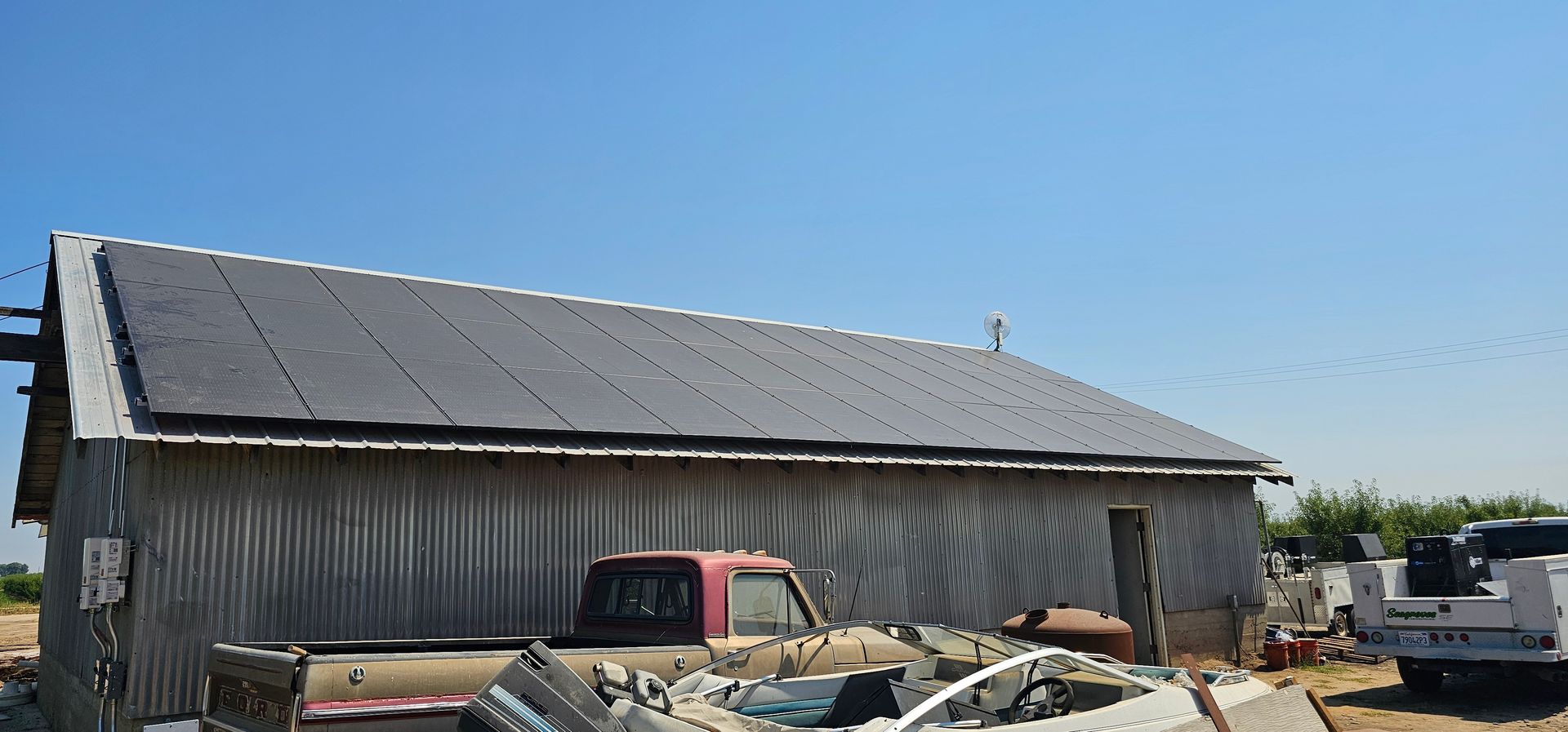 A red truck is parked in front of a building.