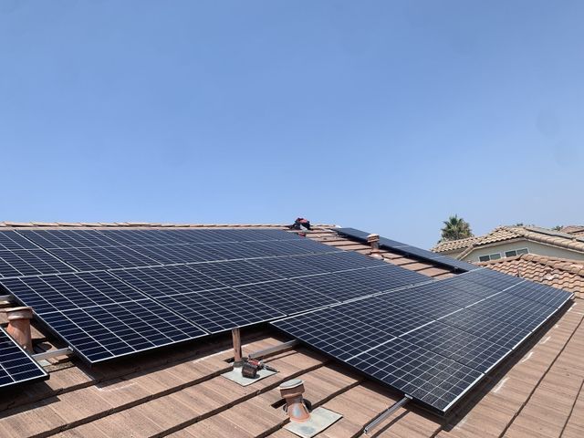 A roof with a lot of solar panels on it