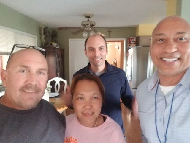 A group of people posing for a picture in a kitchen