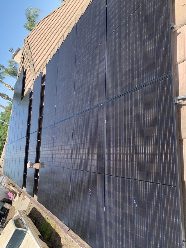 A row of solar panels on the side of a building.