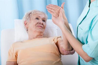 Adult senior receiving rehabilitation with an occupational therapist.