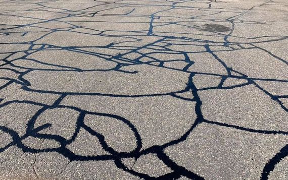 A close up of a cracked asphalt road