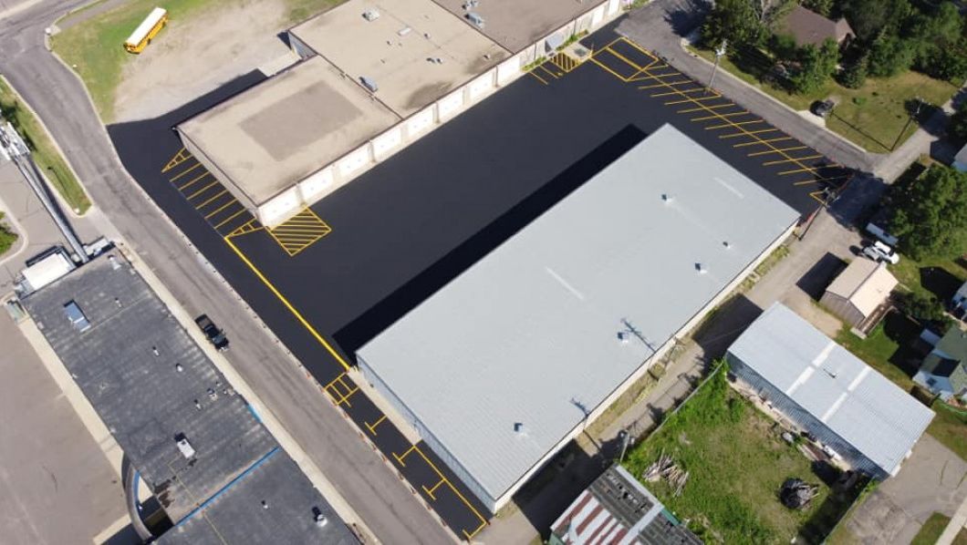 An aerial view of a building with a parking lot in front of it