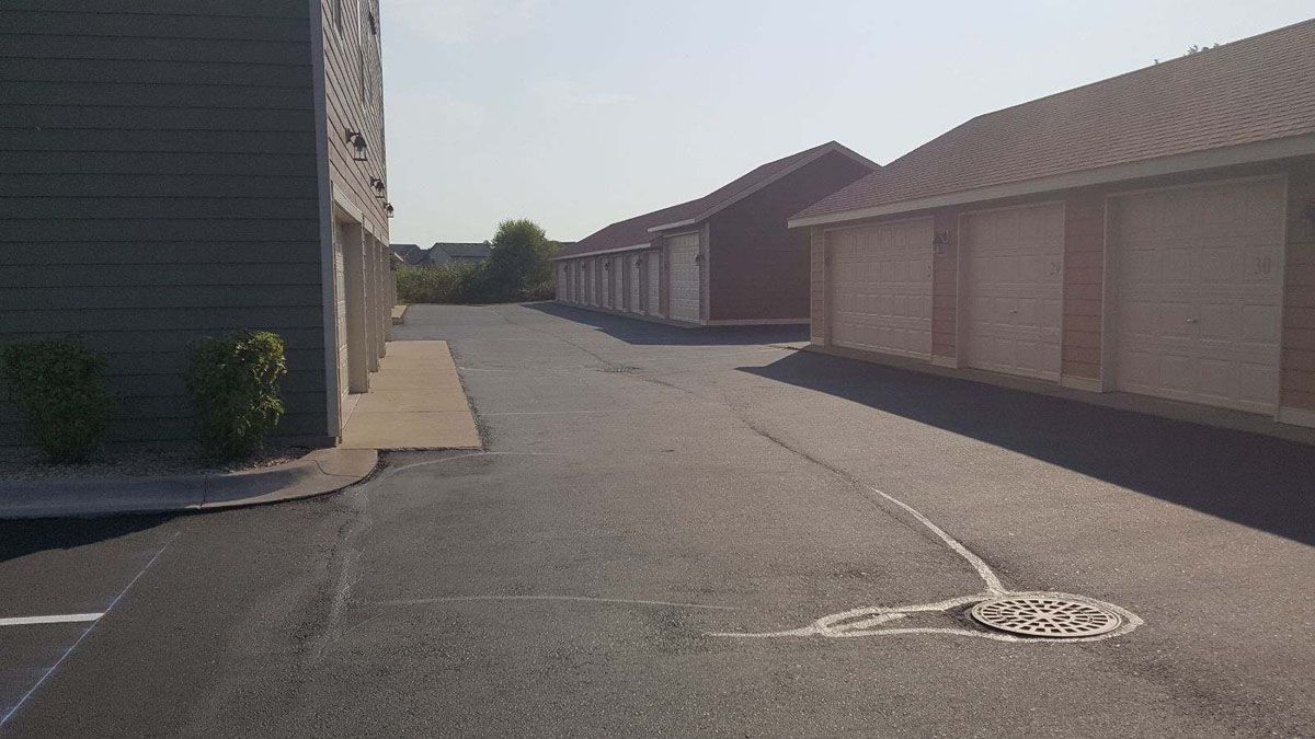 A row of buildings are lined up on the side of a road.