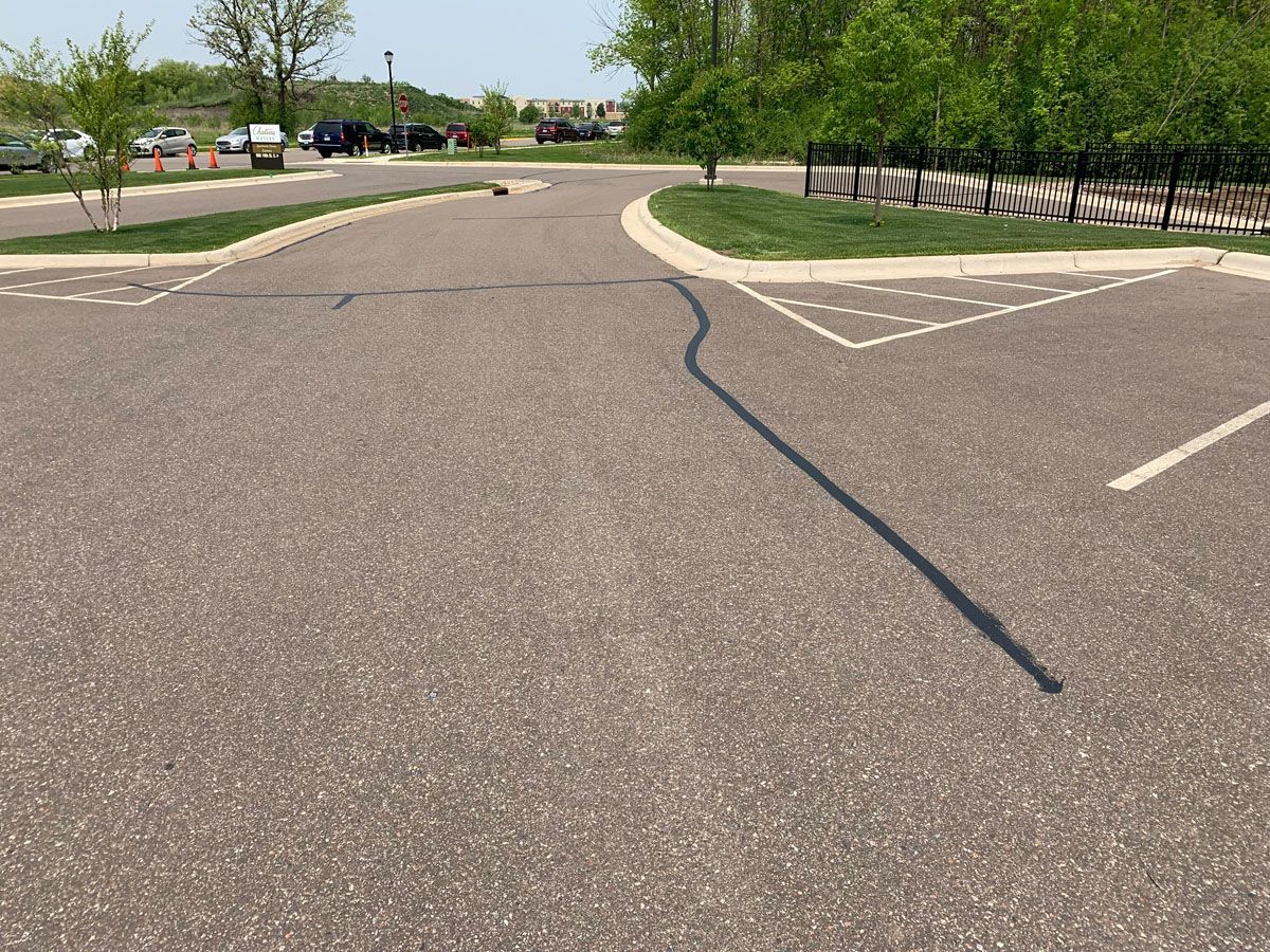 A parking lot with a black line in the middle of it.