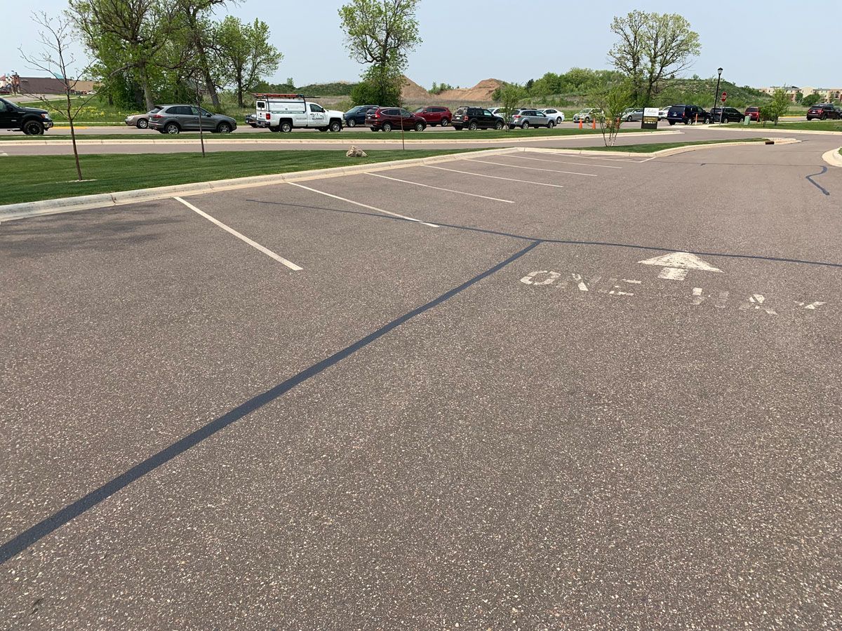 A parking lot with a white arrow pointing to the right