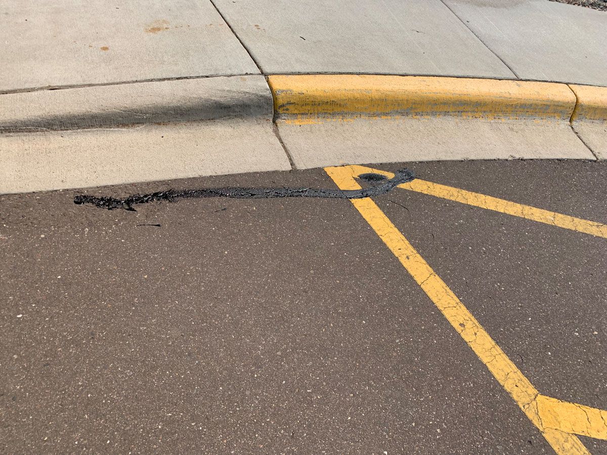 A handicapped parking spot with a yellow line on the side of the road