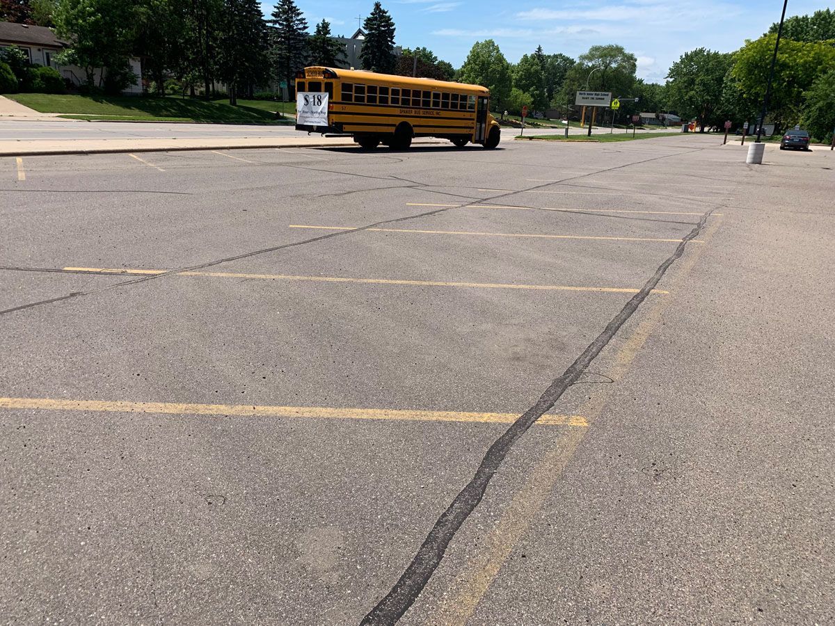 A yellow school bus is parked in a parking lot
