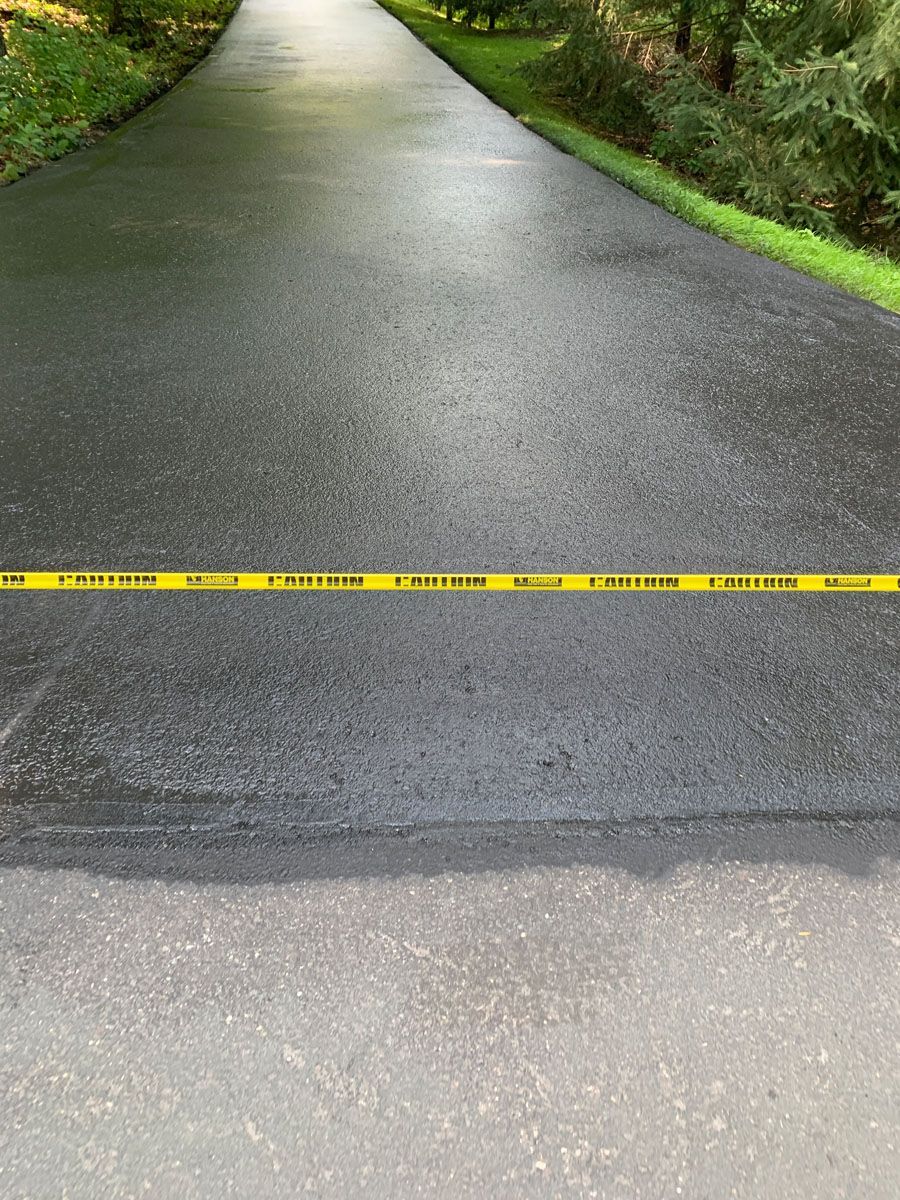 There is a yellow caution tape on the side of the road.