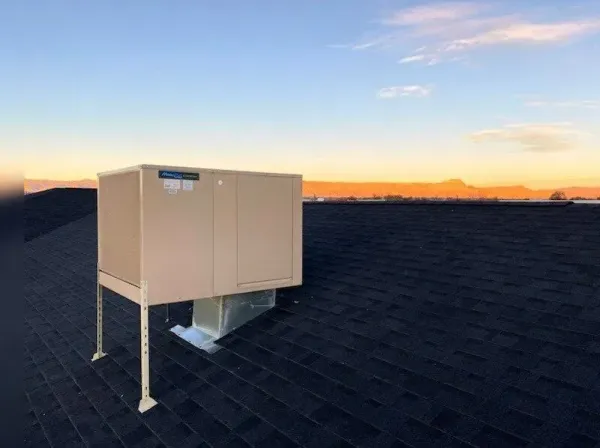 A man wearing a hard hat and goggles is standing in a room.