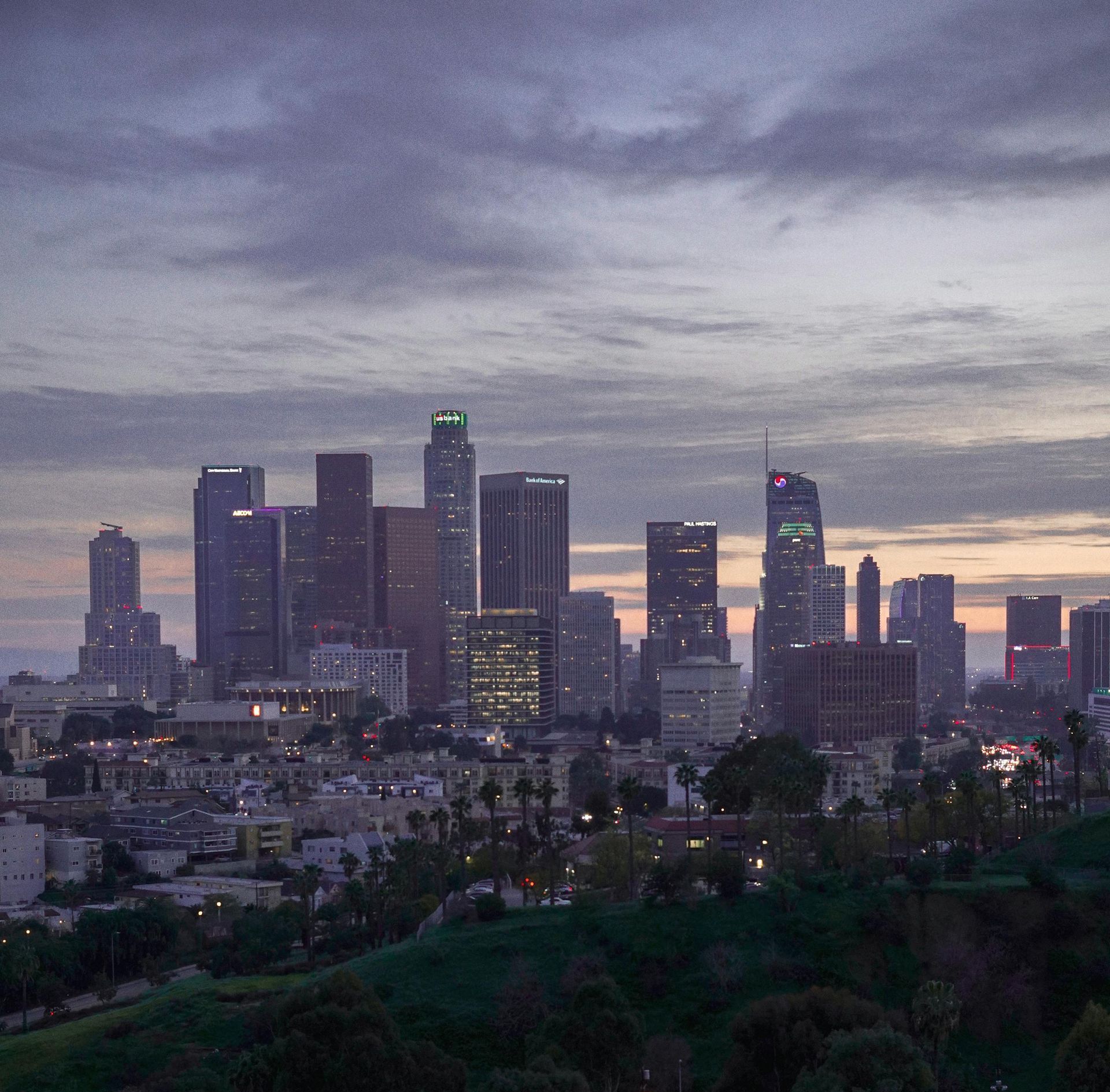 An aerial view of a city skyline at sunset