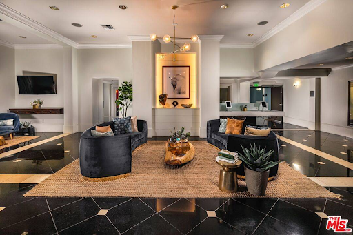 A living room with a couch , chairs , and a coffee table.