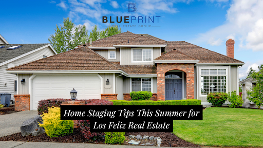 A beautiful suburban home with a well-maintained front yard, featuring brick and gray siding with a shingled roof.