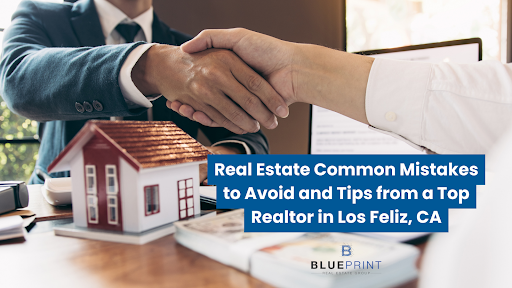 Two people shaking hands over a real estate deal, with a model house and documents on the table in front of them.