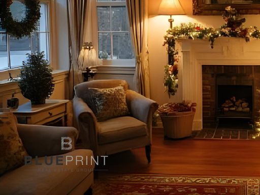 Cozy living room with Christmas decorations: lit fireplace, armchairs, windows with wreath and tree.
