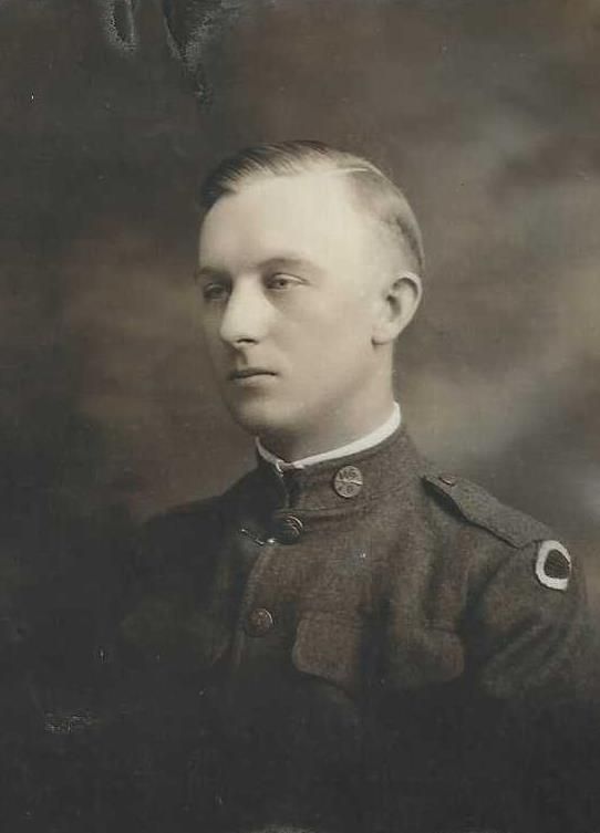 Man in military uniform, facing left, with short hair. Light background, possibly a portrait.