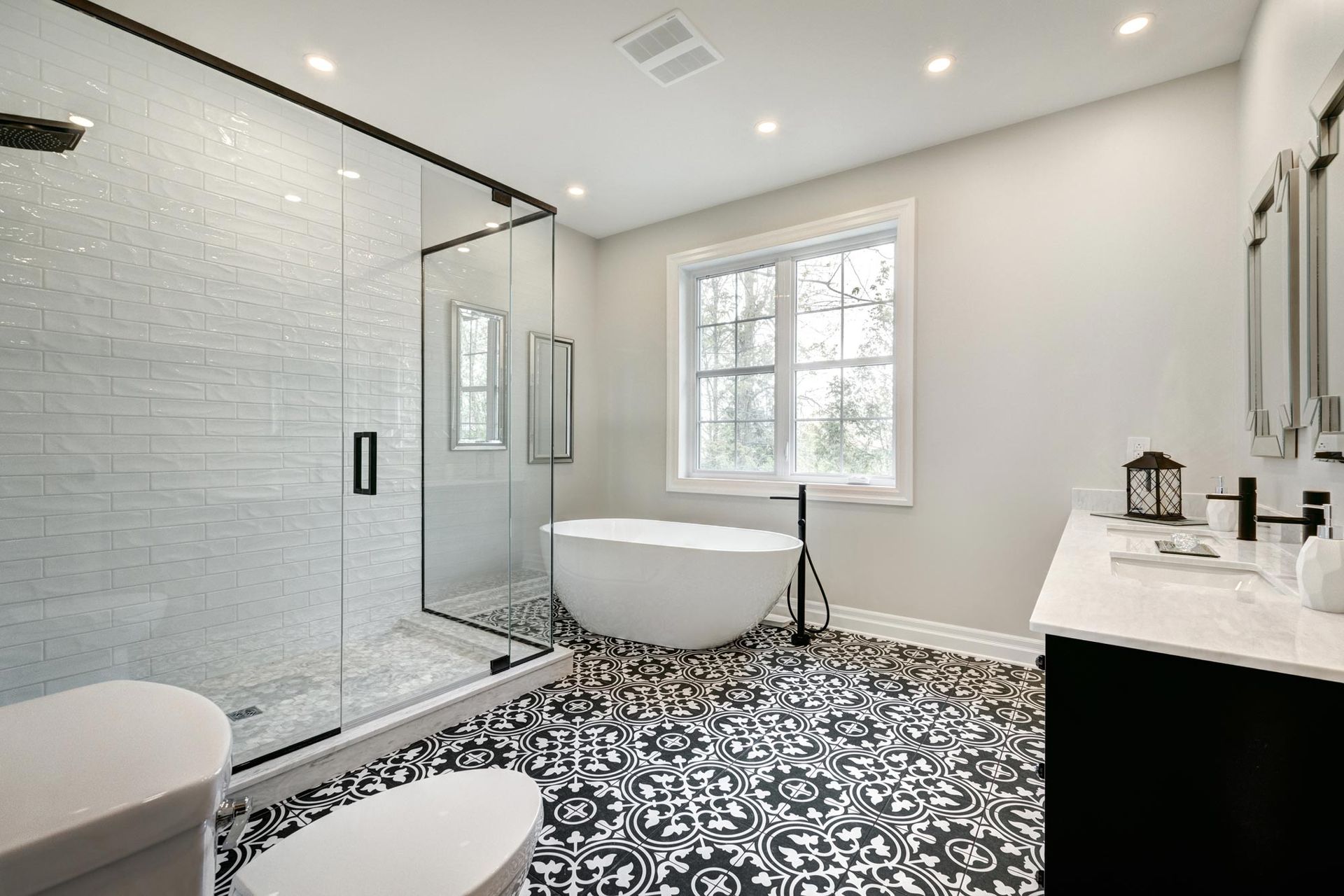 A bathroom with a bathtub , toilet , sink and shower.