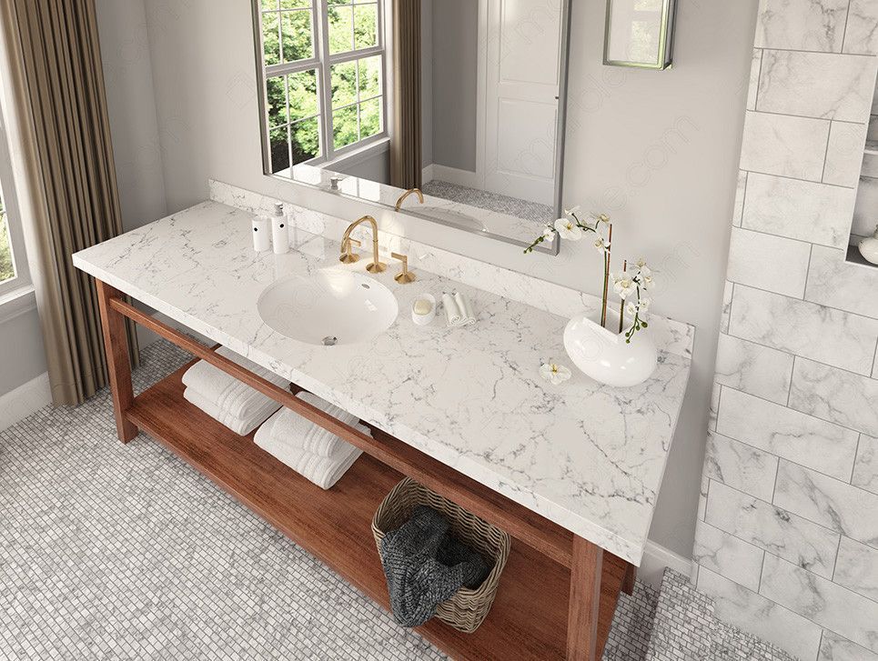 Bathroom vanity with marble countertop, gold faucet, and wooden base, towels and basket below.