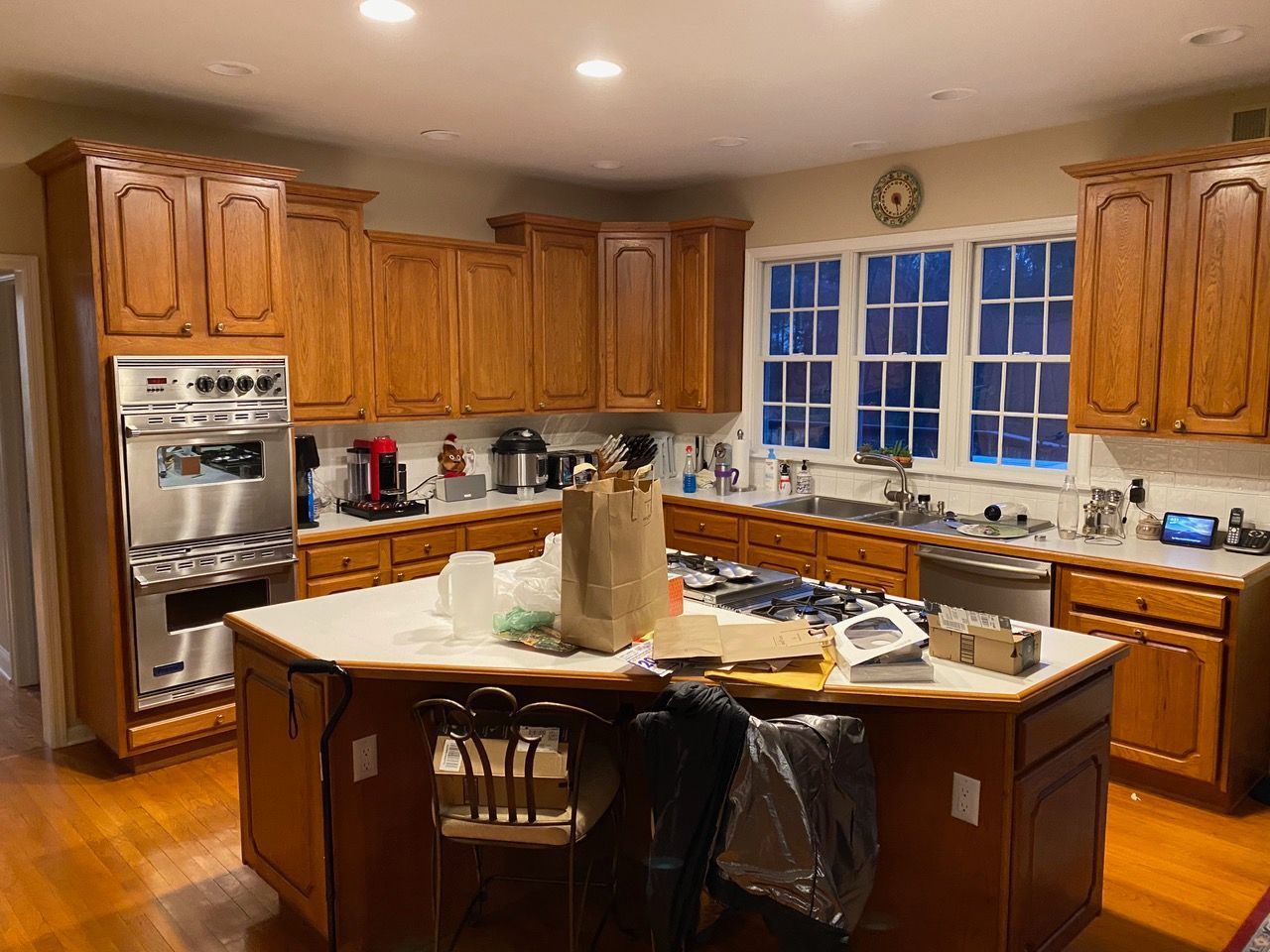 Kitchen with wooden cabinets, stainless steel appliances, an island, and a window.