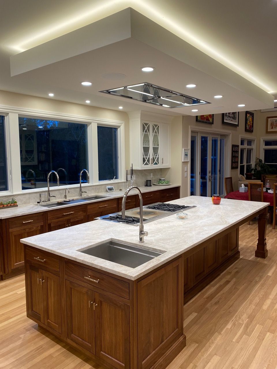 Spacious kitchen with a large island, wooden cabinets, and recessed lighting.