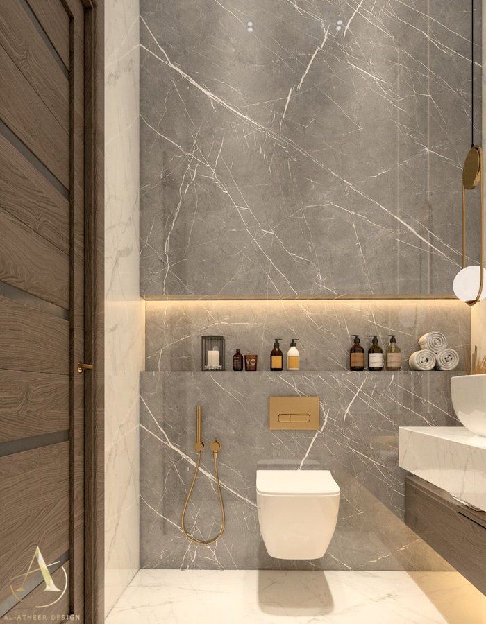 Modern bathroom with gray marble walls, wall-mounted toilet, and a wooden door.