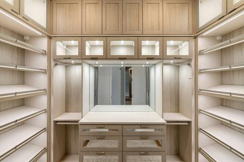 Bathroom with double vanity, two mirrors, glass shower, and frosted glass door.