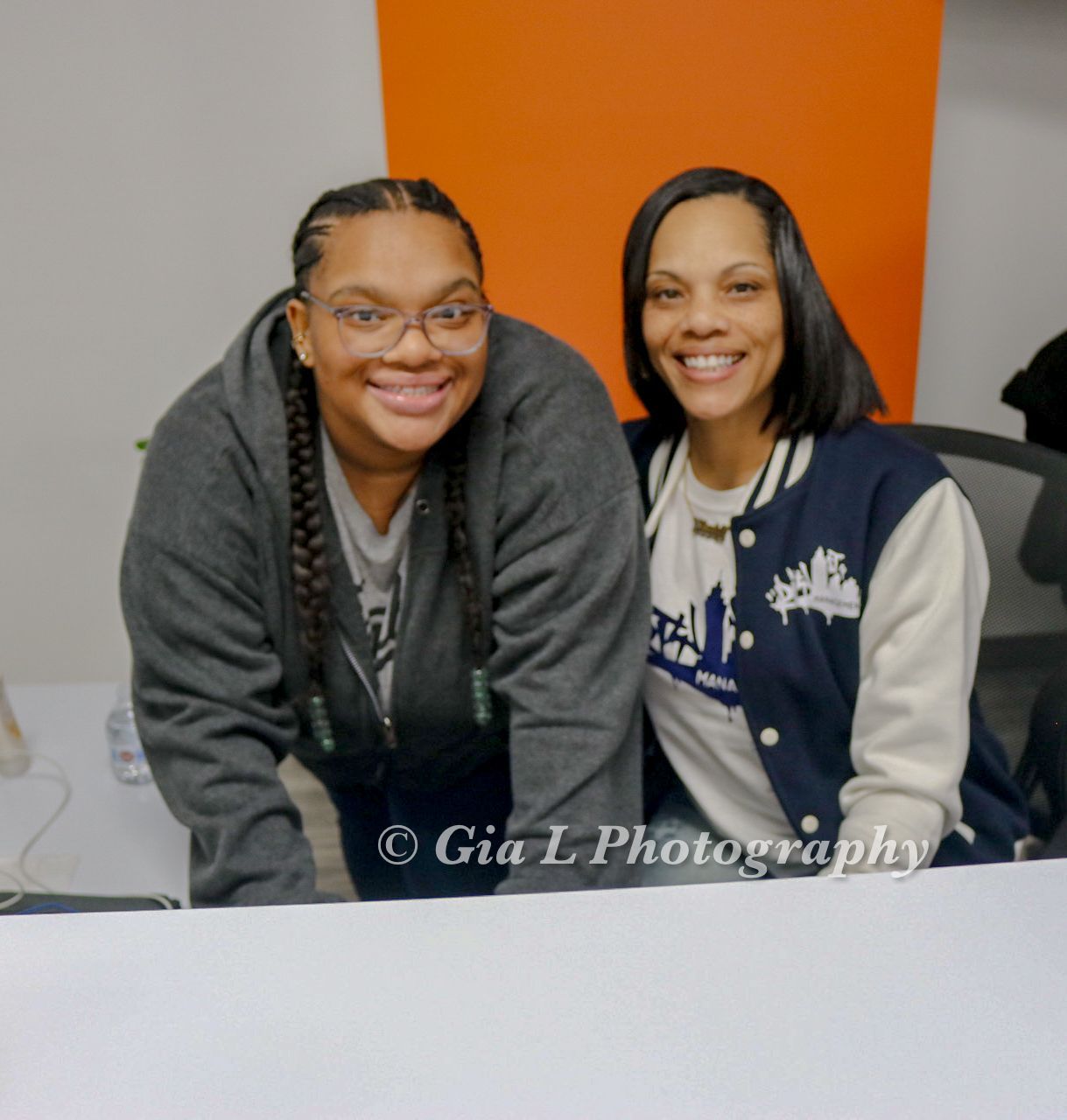 Two women posing for a picture with gia l photography