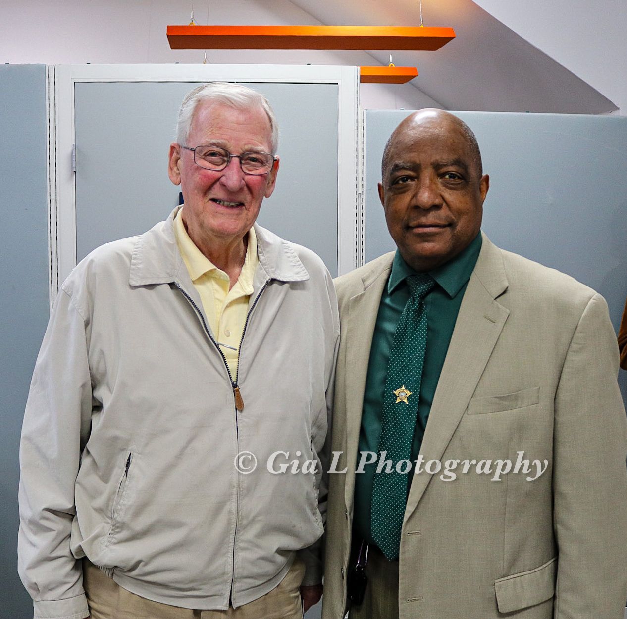 Two men are posing for a picture and the photo was taken by gia l photography