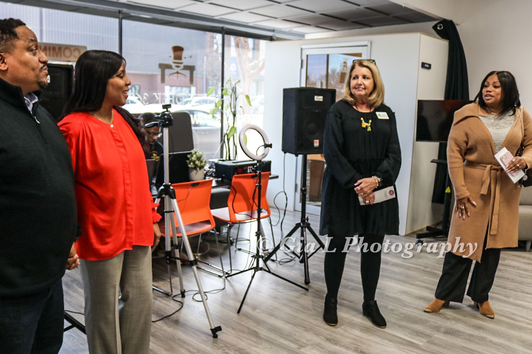 A group of people standing next to each other in a room.