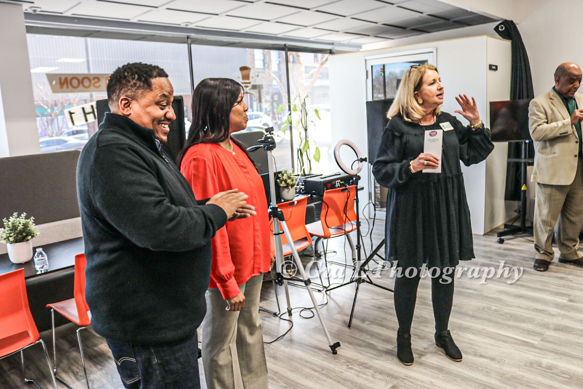 A group of people standing in a room with the word photography on the bottom