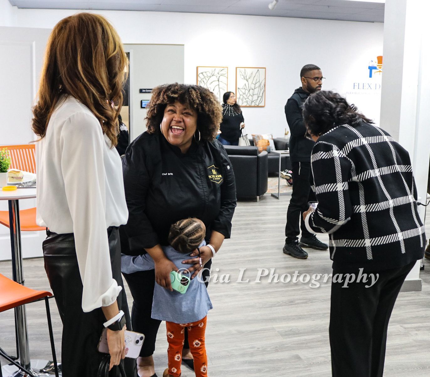 A group of people are standing in a room with the word photography on the bottom