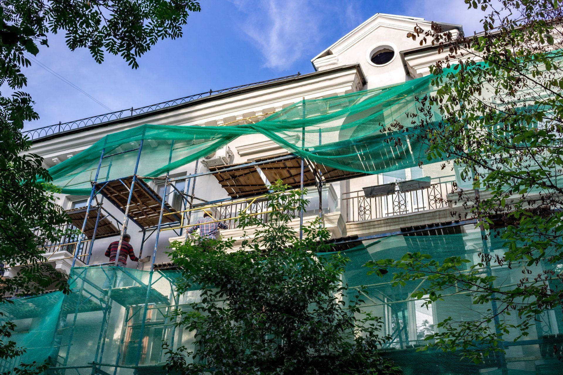 A large building is being remodeled with scaffolding around it.