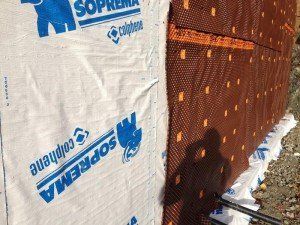 A brown wall with a white bag on it that says ' suprema ' on it.