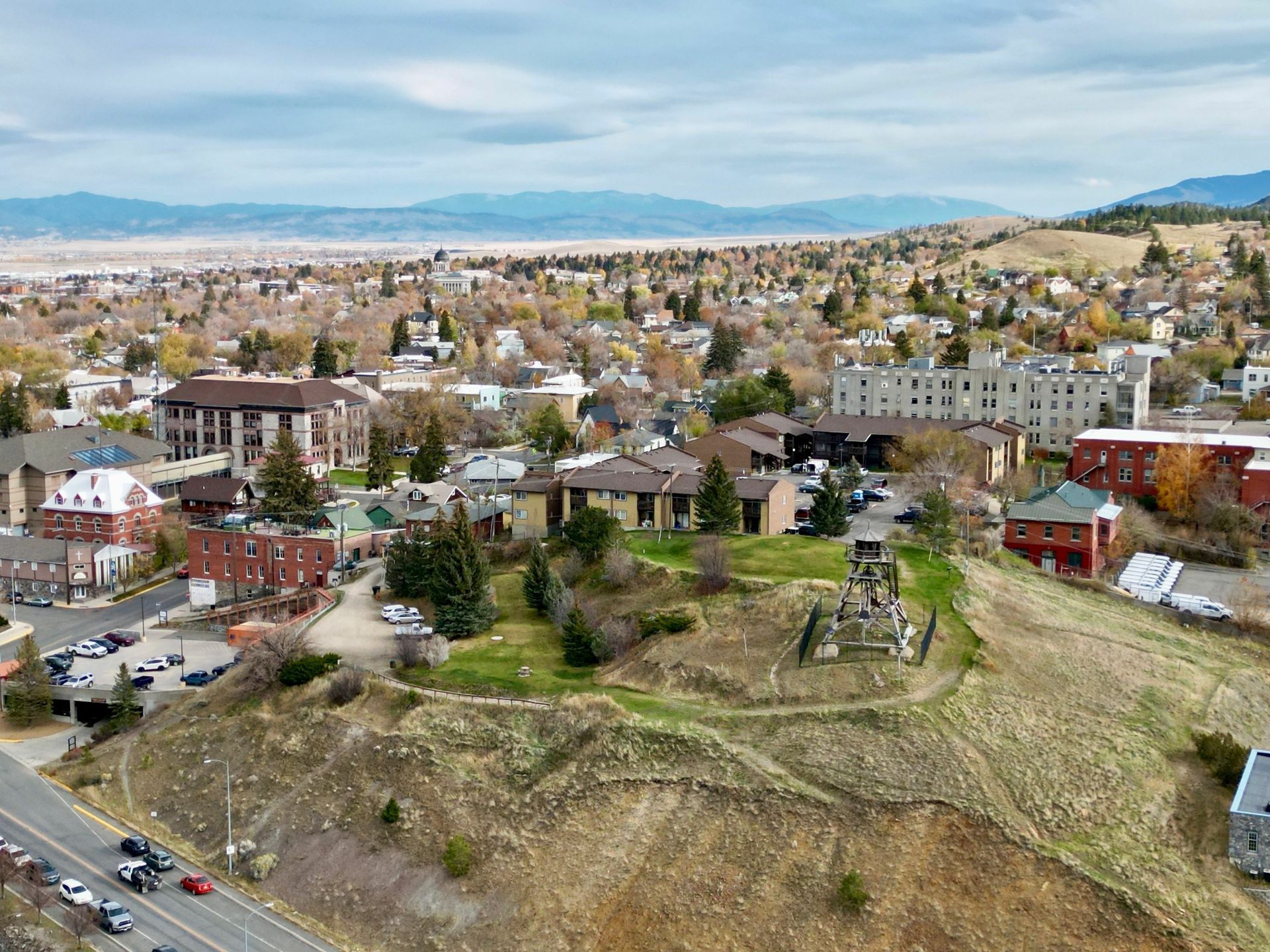 An aerial view of a small town with mountains in the background.