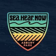 A logo for sea hear now asbury park on a blue background.