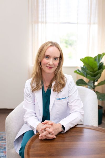 Doctor Erin Glassman in a clinic, smiling.