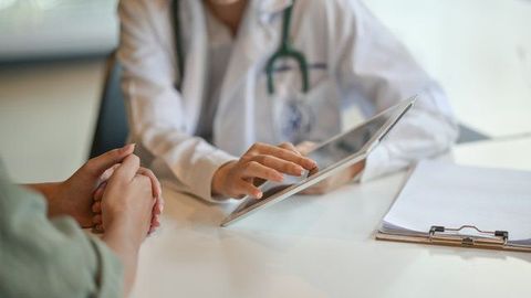 female doctor reviewing results with patient in a soft-lit indoor setting
