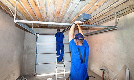 Workers installing garage doors in Sparta