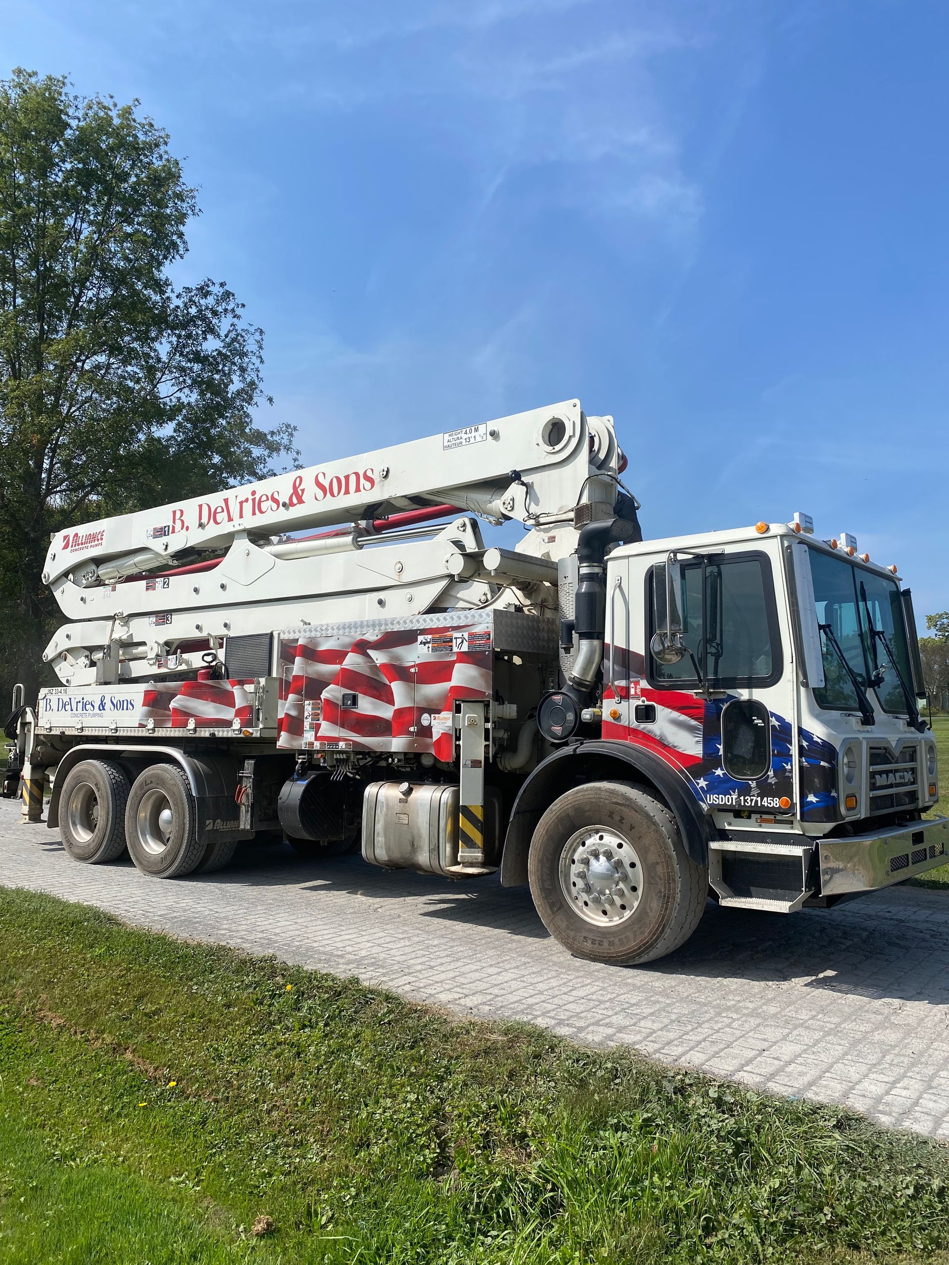 A concrete pump truck is parked on the side of the road.