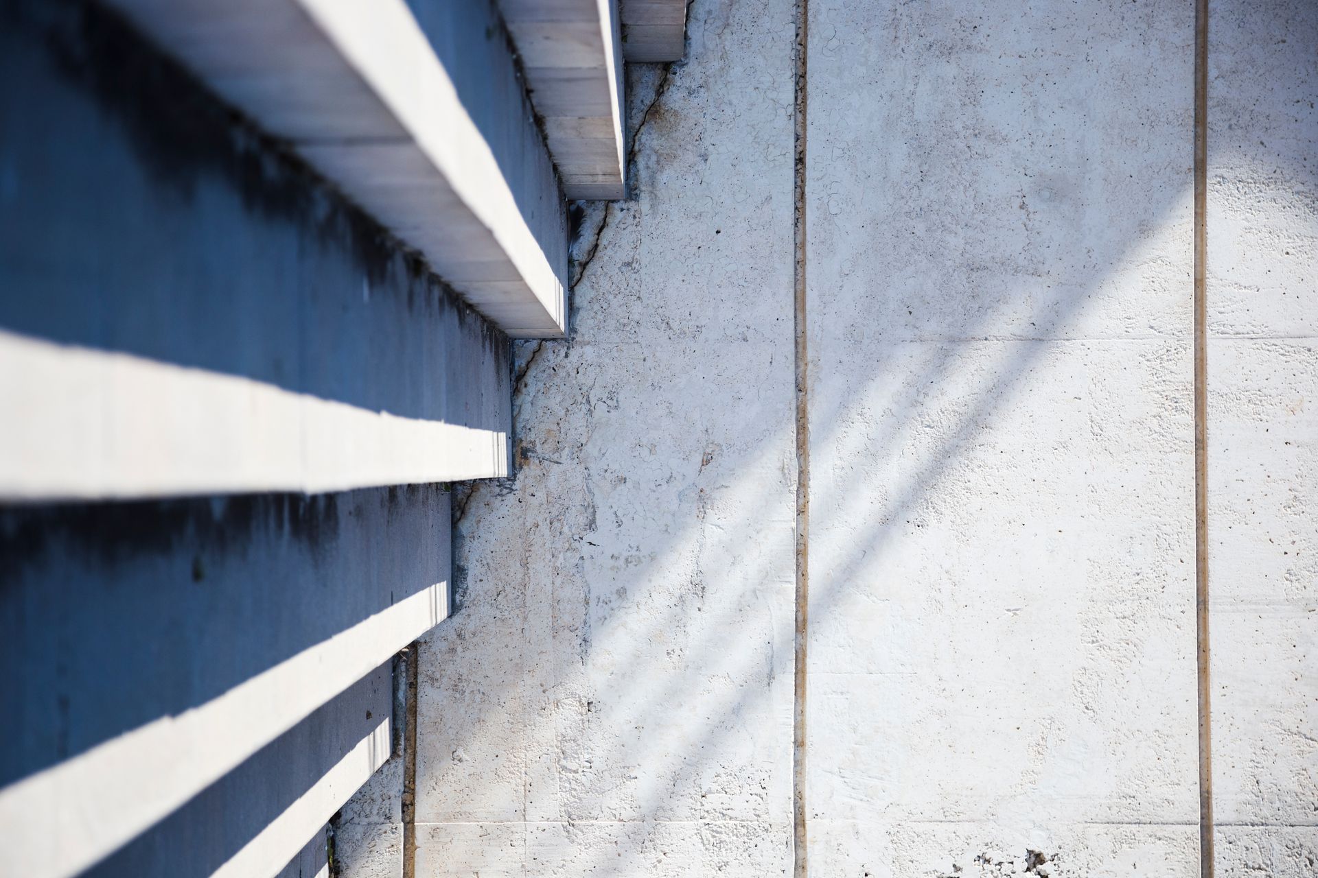 A close up of a concrete wall with a shadow on it.