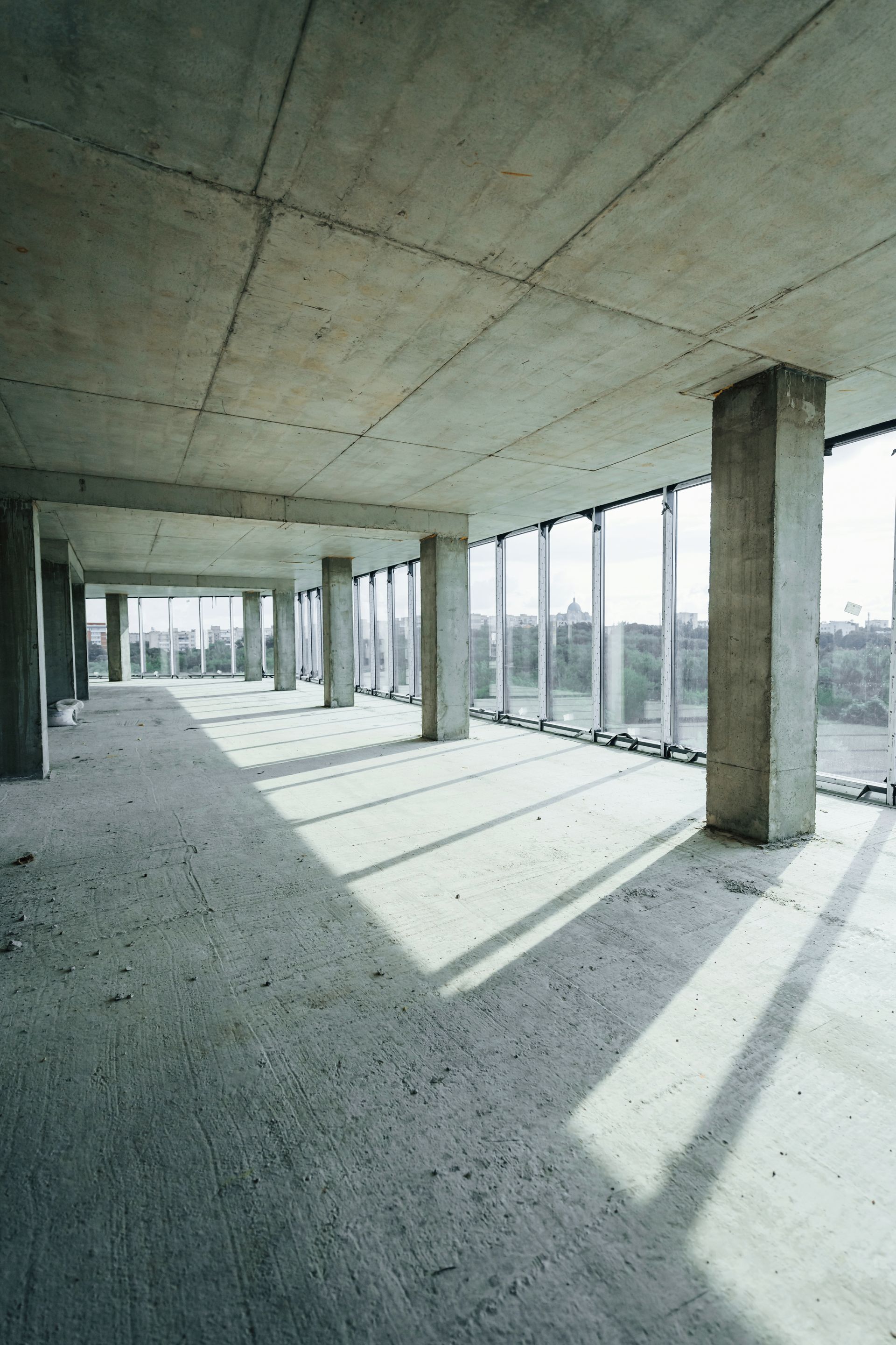 An empty building with a lot of windows and columns.