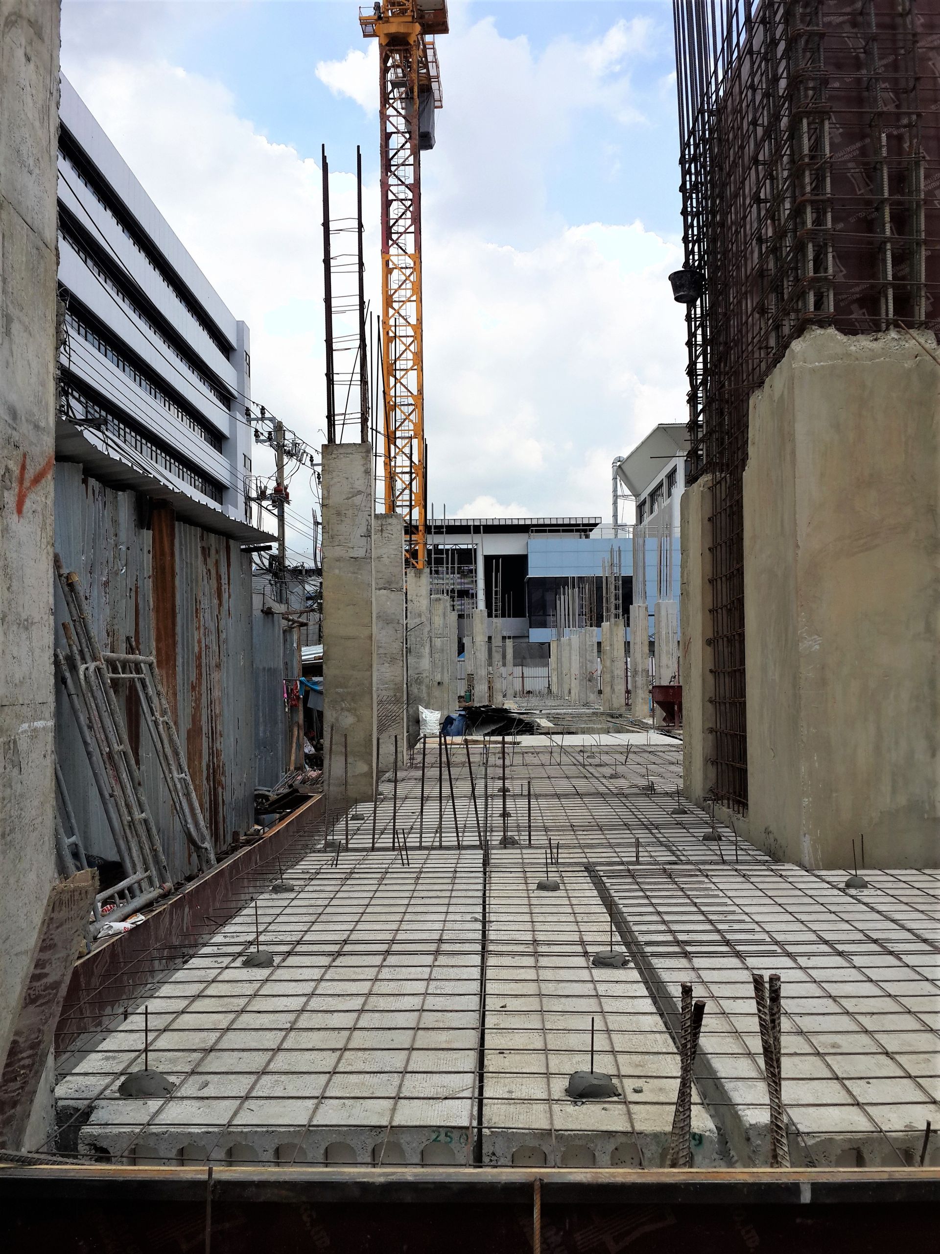 A construction site with a crane in the background.