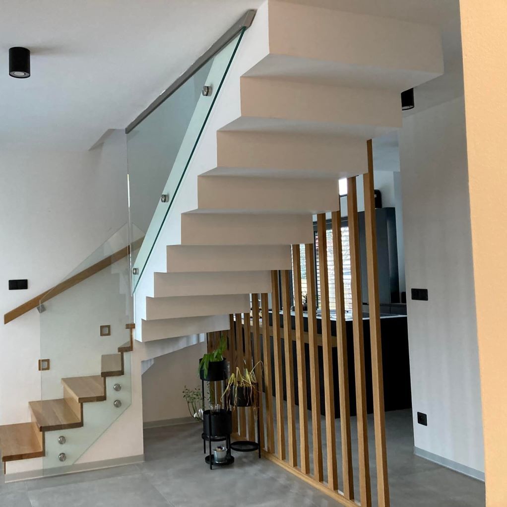 Un escalier avec une rampe en verre et une rampe en bois