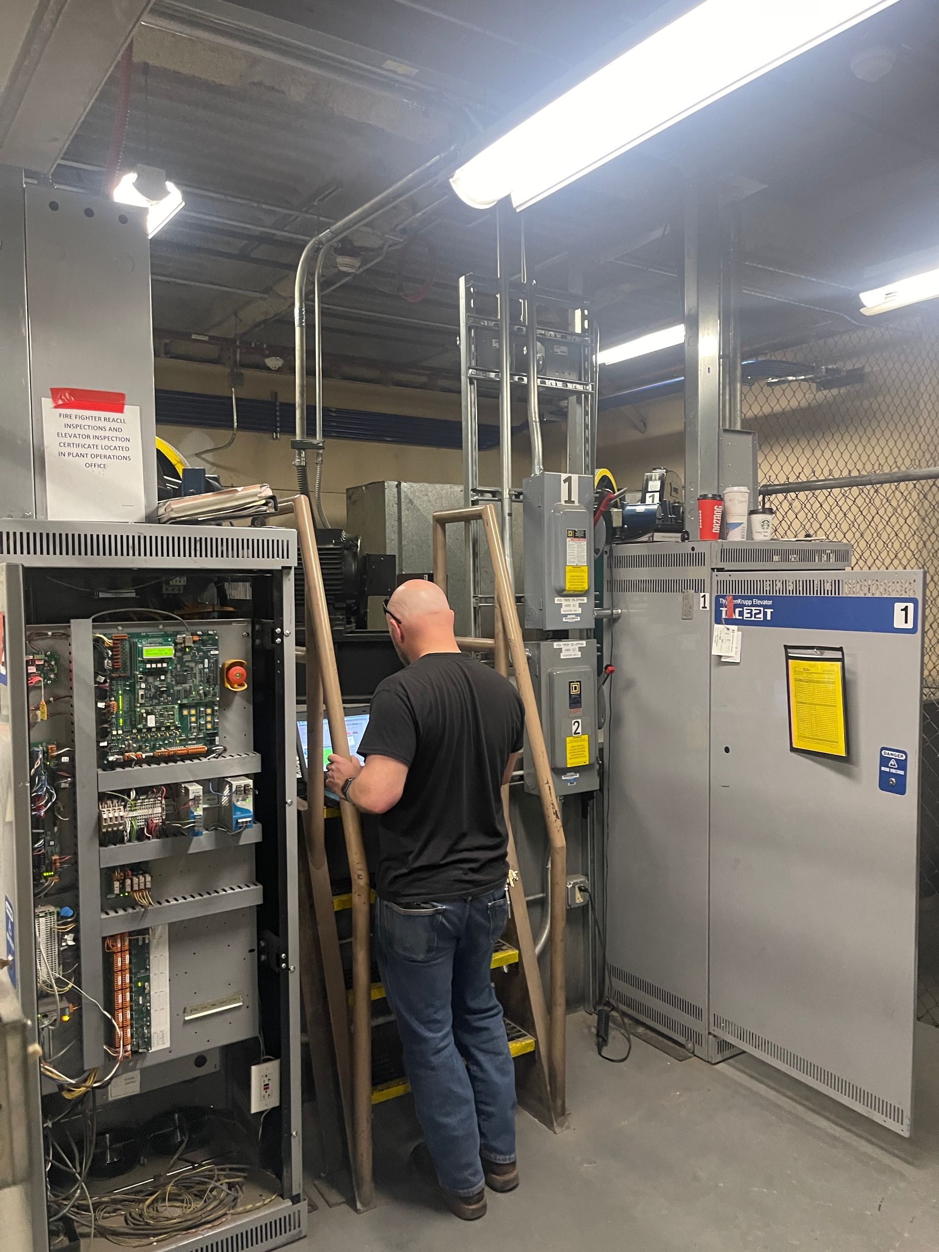 Elevator consultant inspecting an elevator controller
